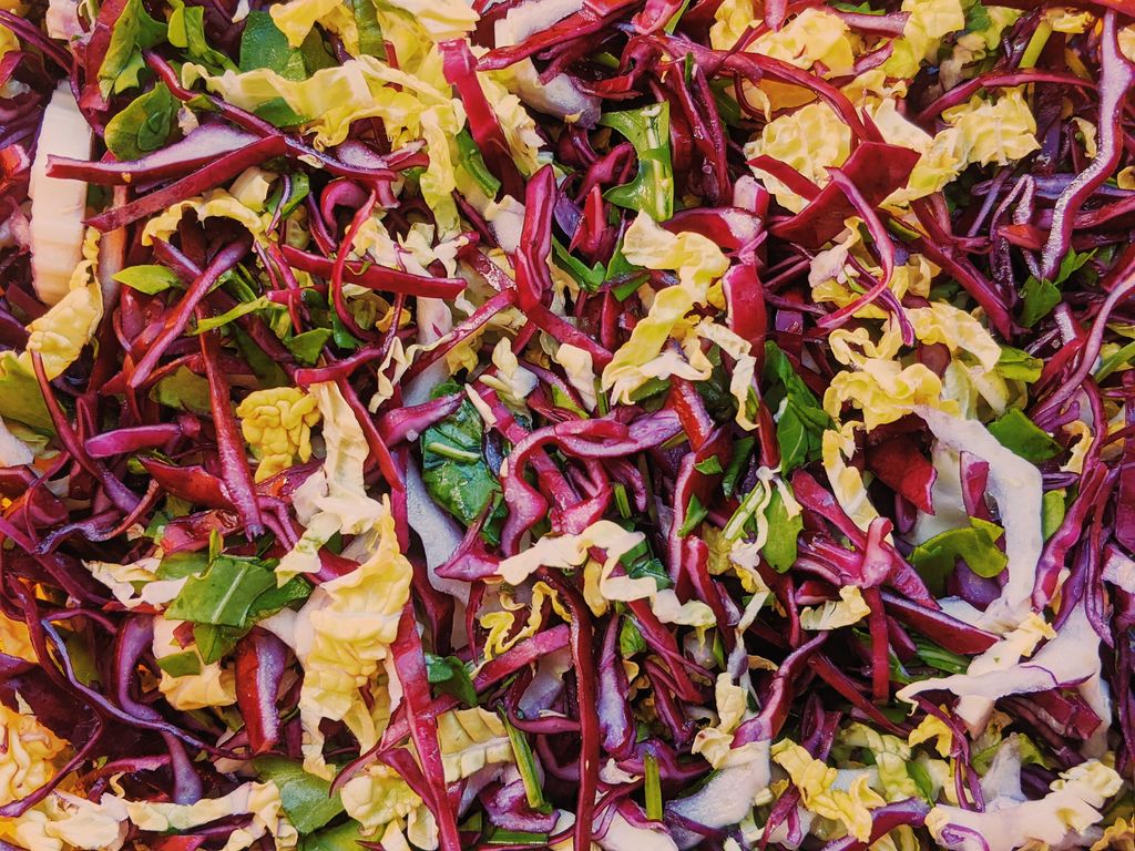 Photo by Zizi zi Top view of tasty multicolored salad with healthy red and Chinese cabbage mixed together with fresh chopped green arugula leaves