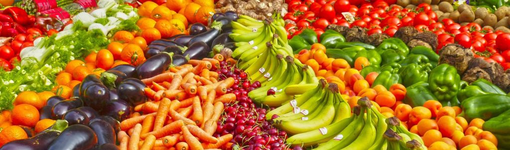 Vibrant selection of fresh fruits and vegetables on a market stall. Healthy eating and organic living.